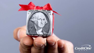 One dollar bill wrapped in a red ribbon